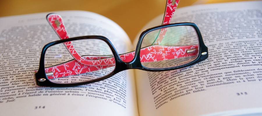 eyeglasses on open book