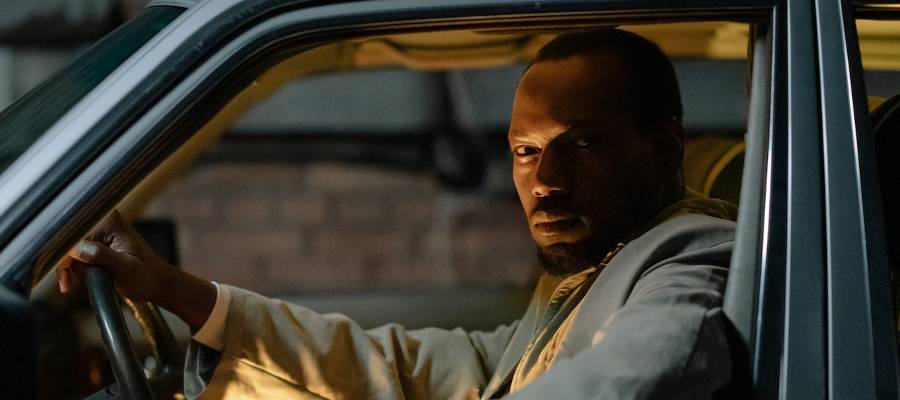 man peering out of car, representing detective man peering out of car, representing detective