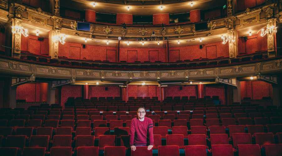 man standing in theater man standing in theater