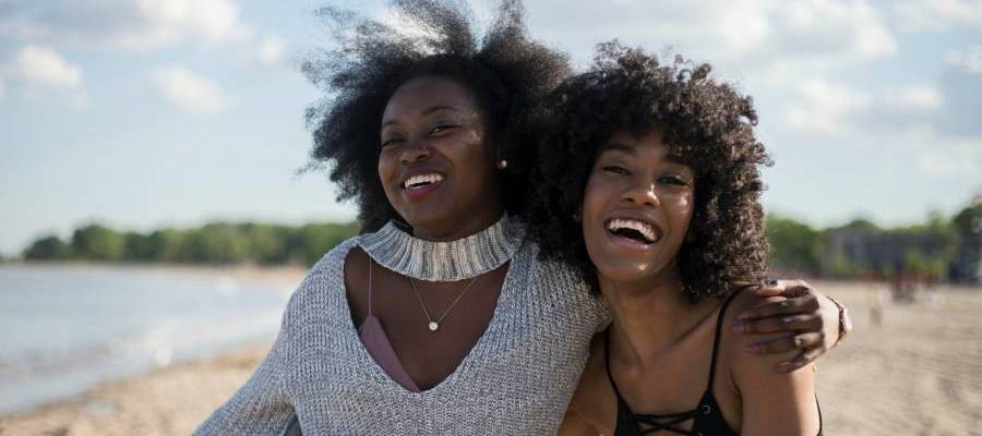 two women laughing two woman laughing together