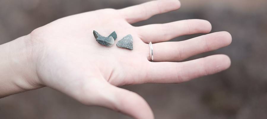 outstretched hand holding rocks or fossils outstretched hand holding rocks or fossils