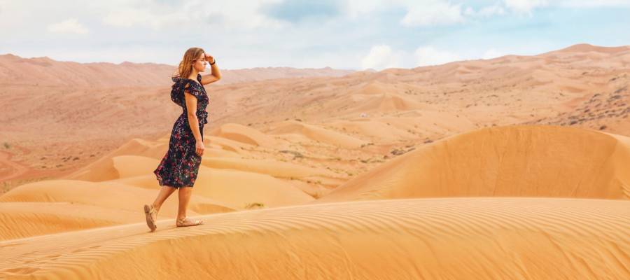woman walking in desert woman walking in desert