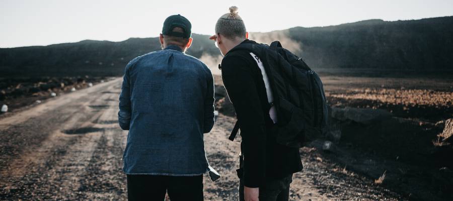 two men looking at train tracks two men looking at train tracks
