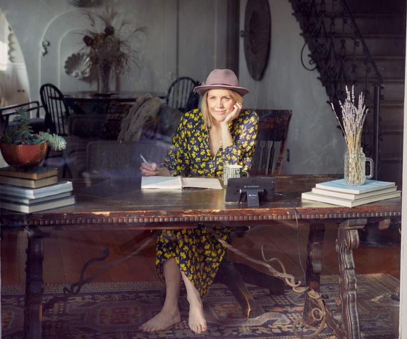 woman writing in window, representing novel-writing tips