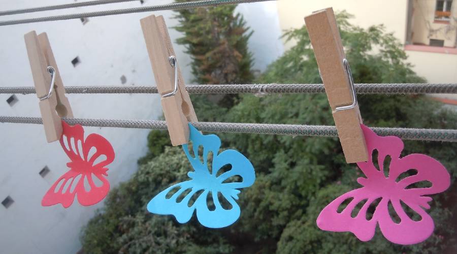 paper butterflies on clothesline to illustrate a page on poetry meter