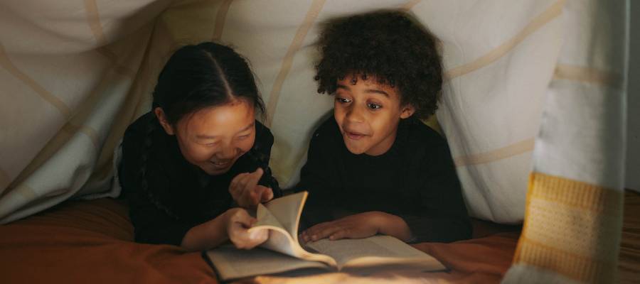 children reading in tent