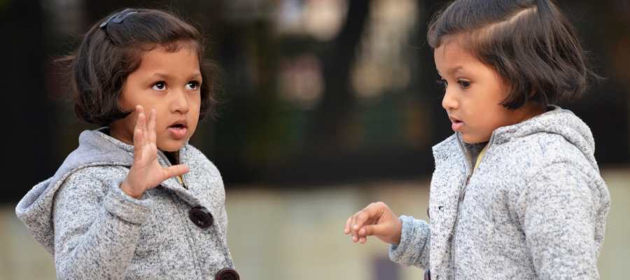 child gesticulating as she speaks child gesticulating as she speaks