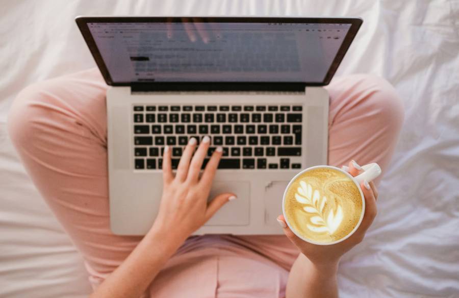 woman with laptop and cappuccino woman holding laptop and cappuccino