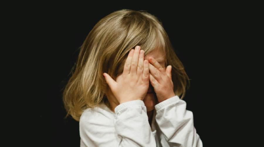 young girl covering eyes young girl covering eyes