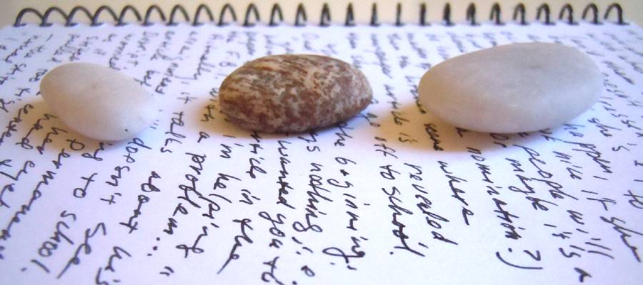 writing journal with stones on top writing journal with stones on top